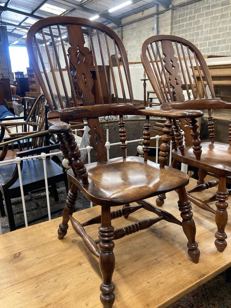 A near pair of 19th century ash and elm Yorkshire Windsor armchairs, larger width 63cm, depth 48cm, height 114cm